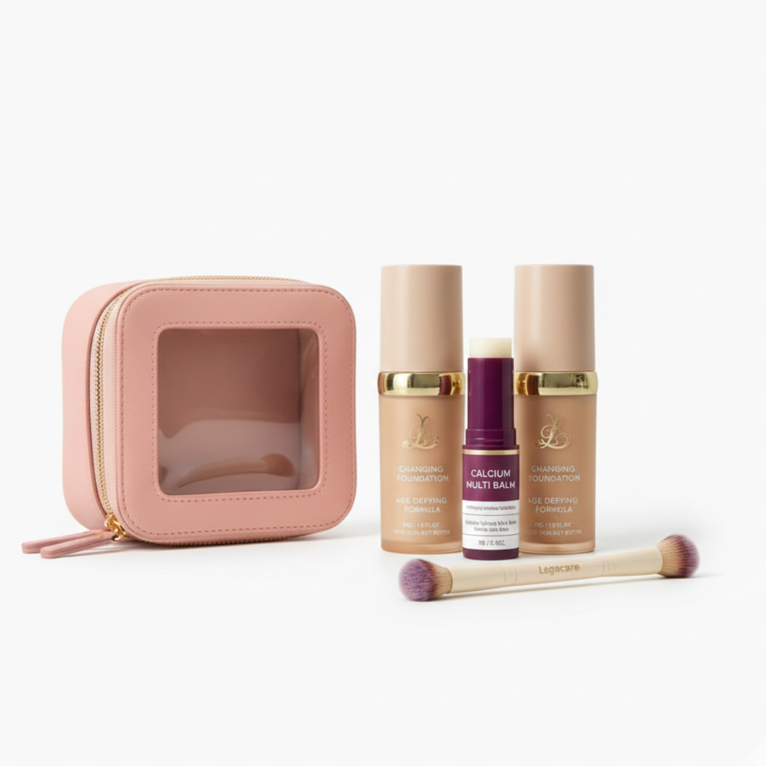 A pink makeup bag with foundation, balm, and a double-ended brush on a white background.