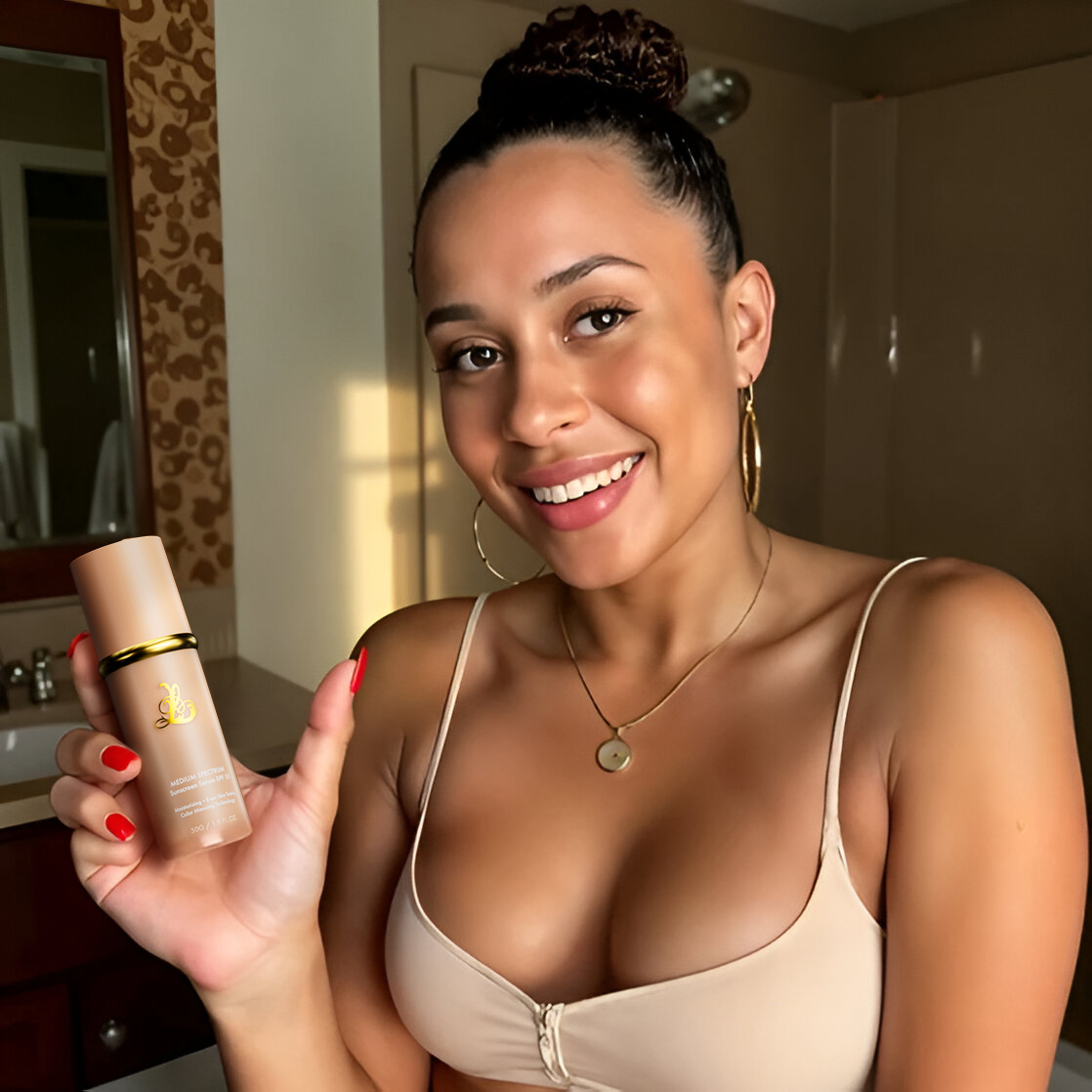 Smiling woman holding a skincare product in a bathroom.