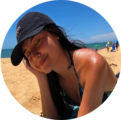 Woman in a cap relaxing on a sunny beach.
