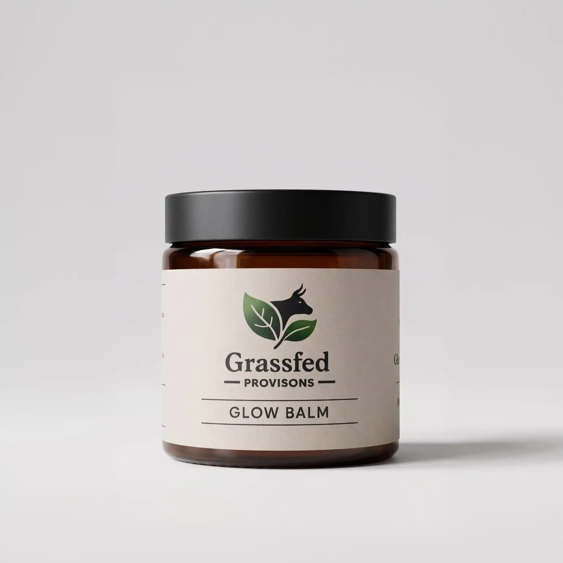 A brown glass jar of Grassfed Provisions Glow Balm with a black lid on a white background.