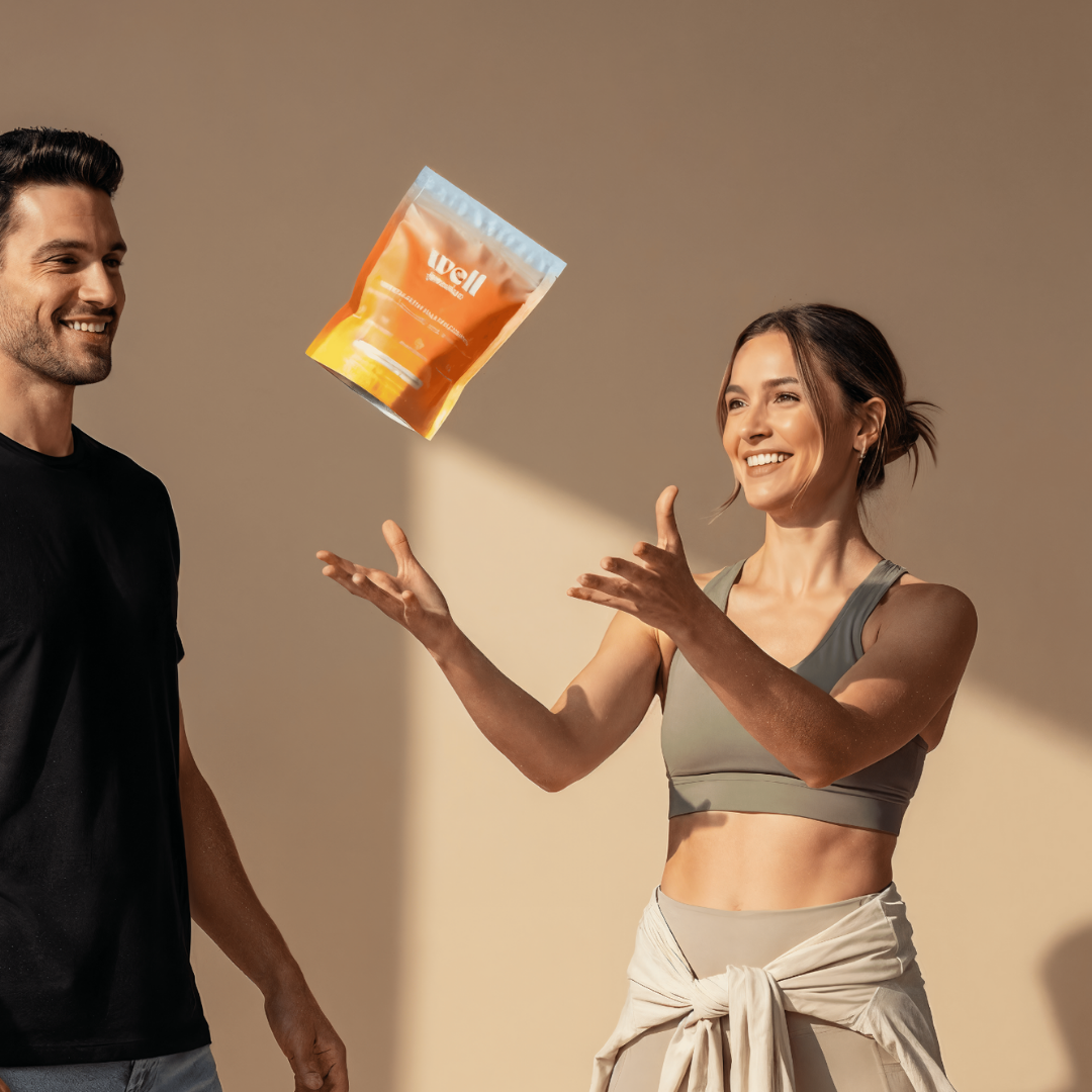 Two people smiling, one tossing a package labeled 'Well' in the air.