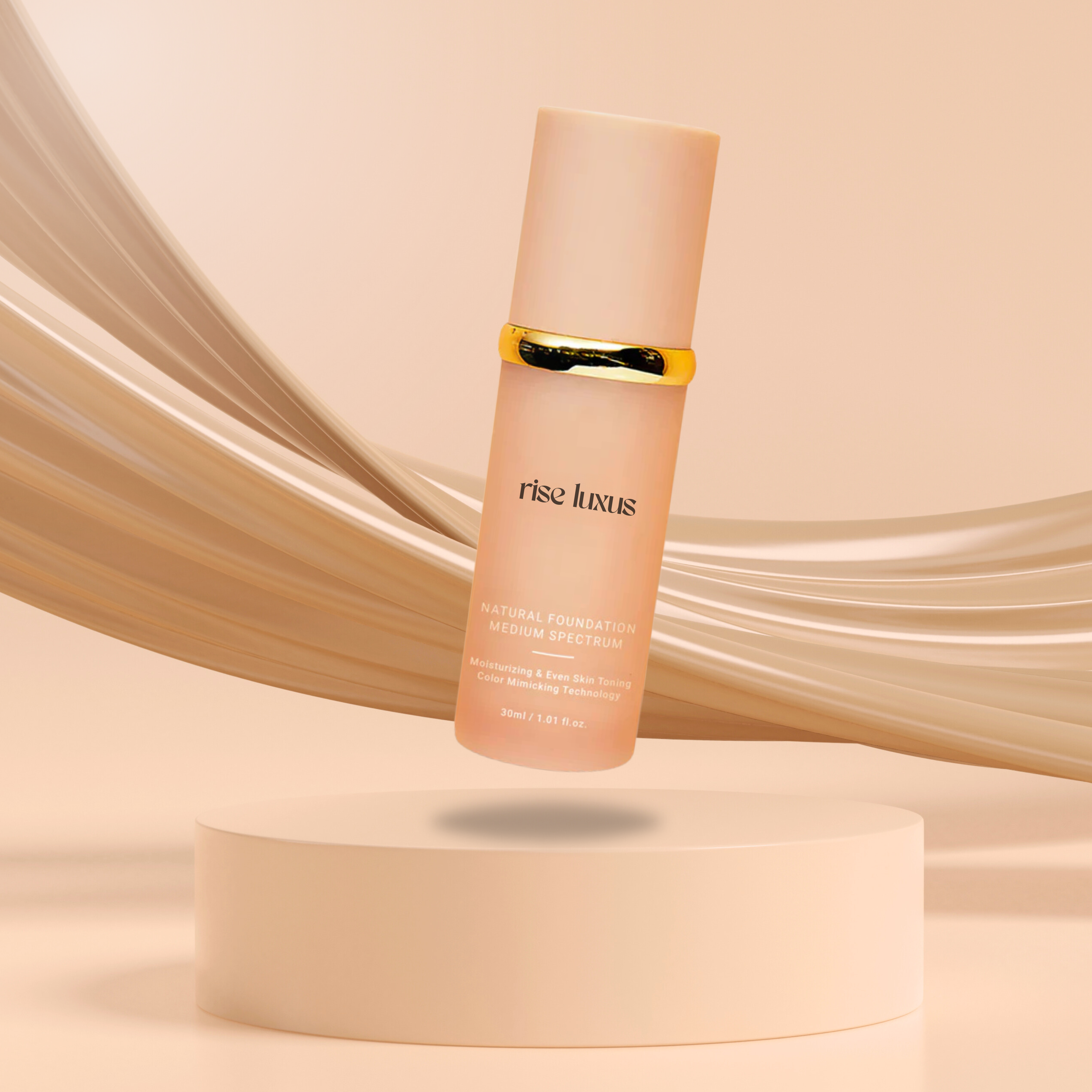 A beige bottle of foundation with gold band, on a round pedestal, curved backdrop.