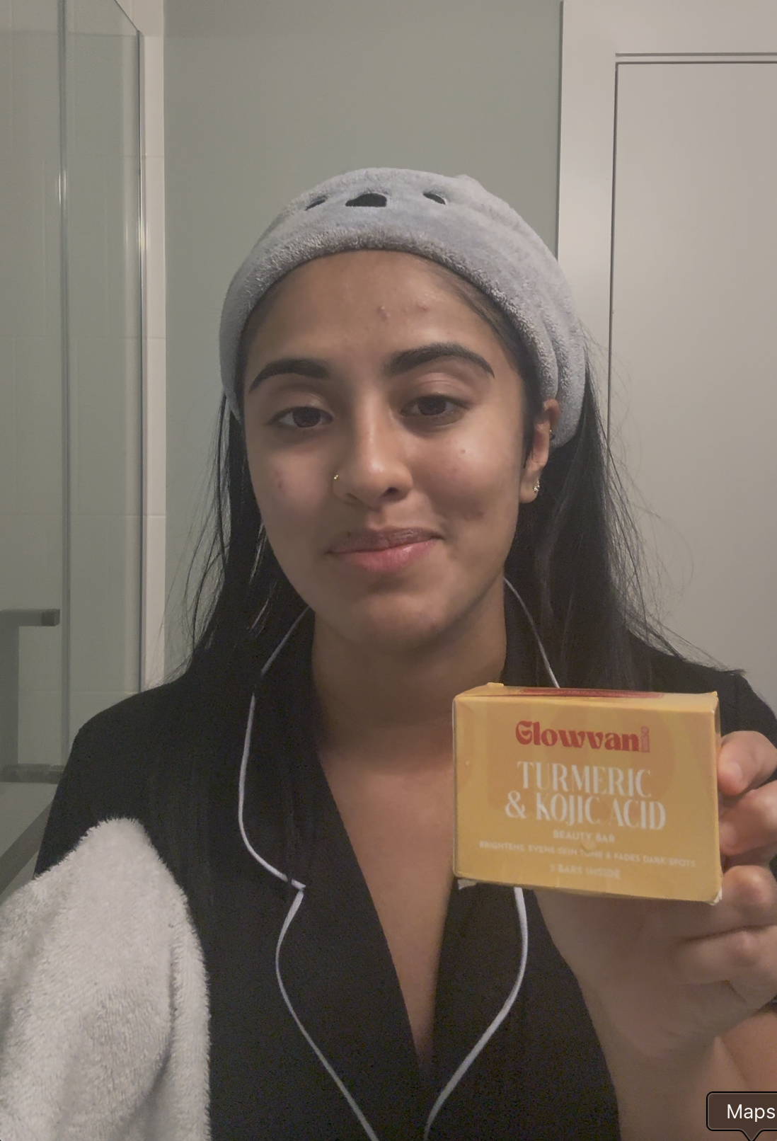 Person holding a box of Glowvani turmeric and kojic acid beauty bar.