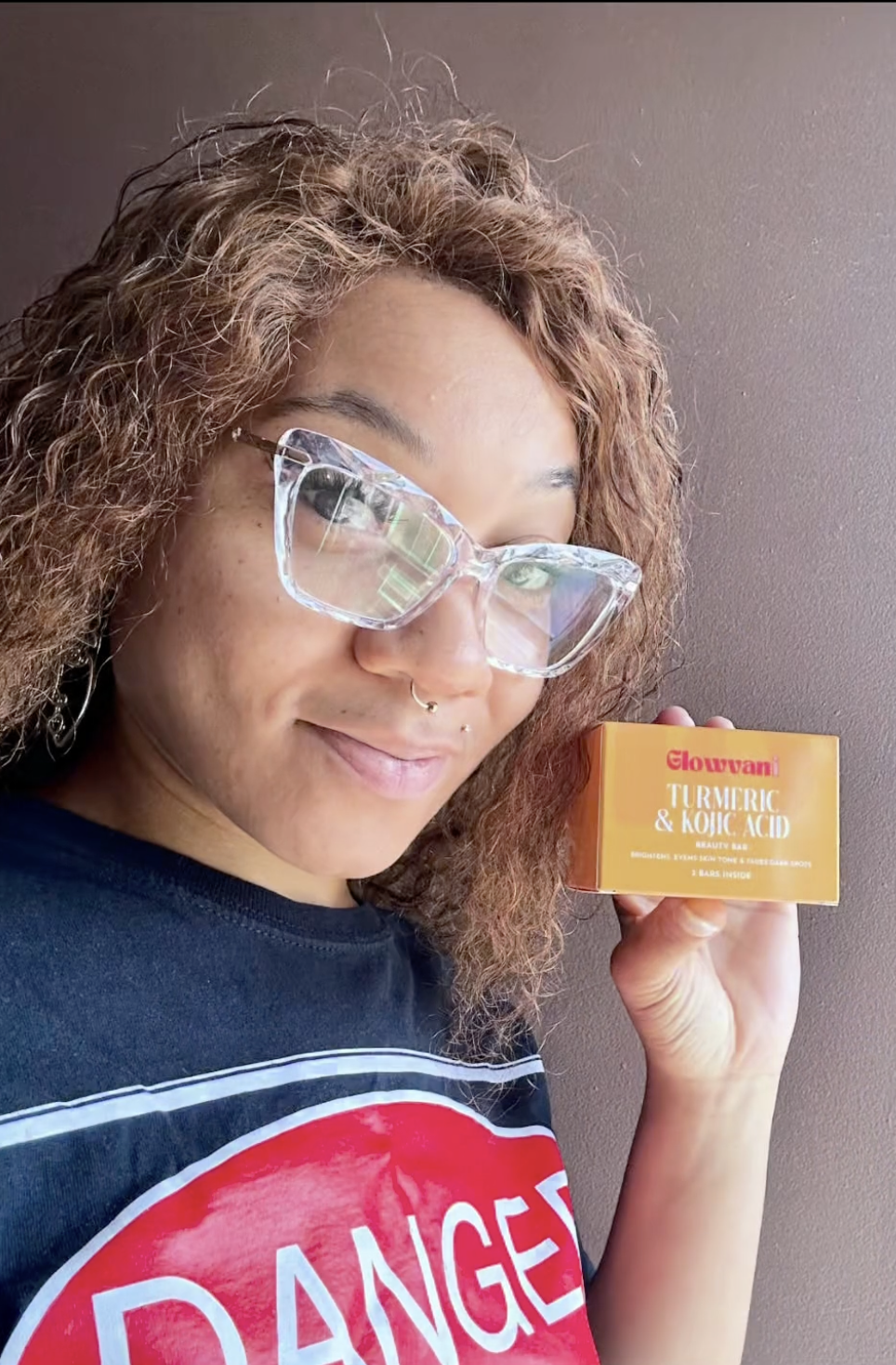 Person holding a turmeric and kojic acid beauty bar.