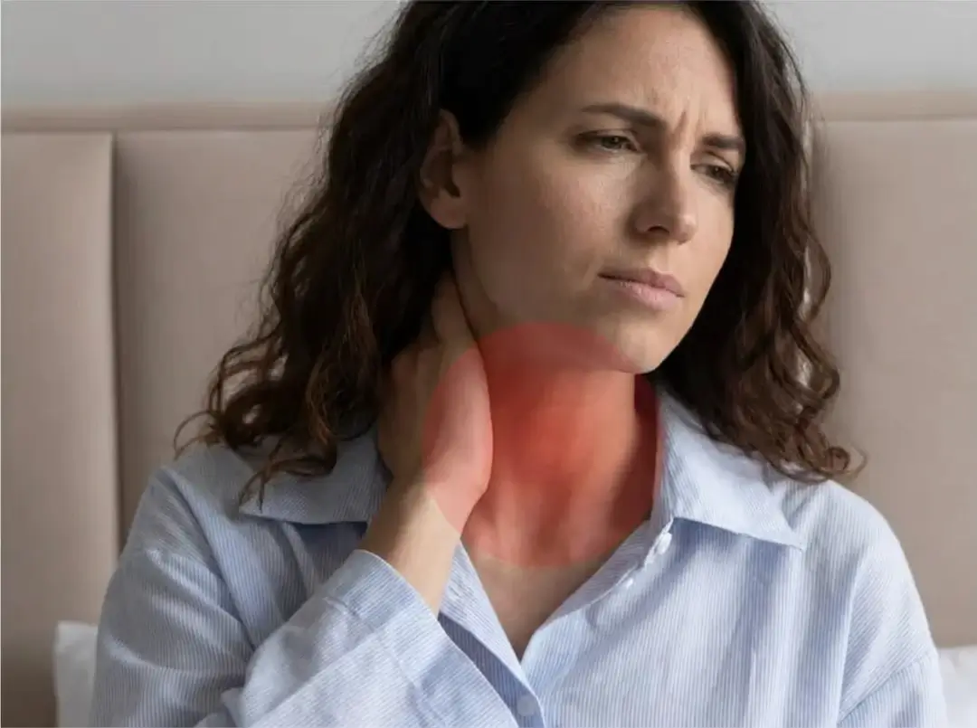 A woman with a pained expression holds her throat, with a red overlay indicating soreness.