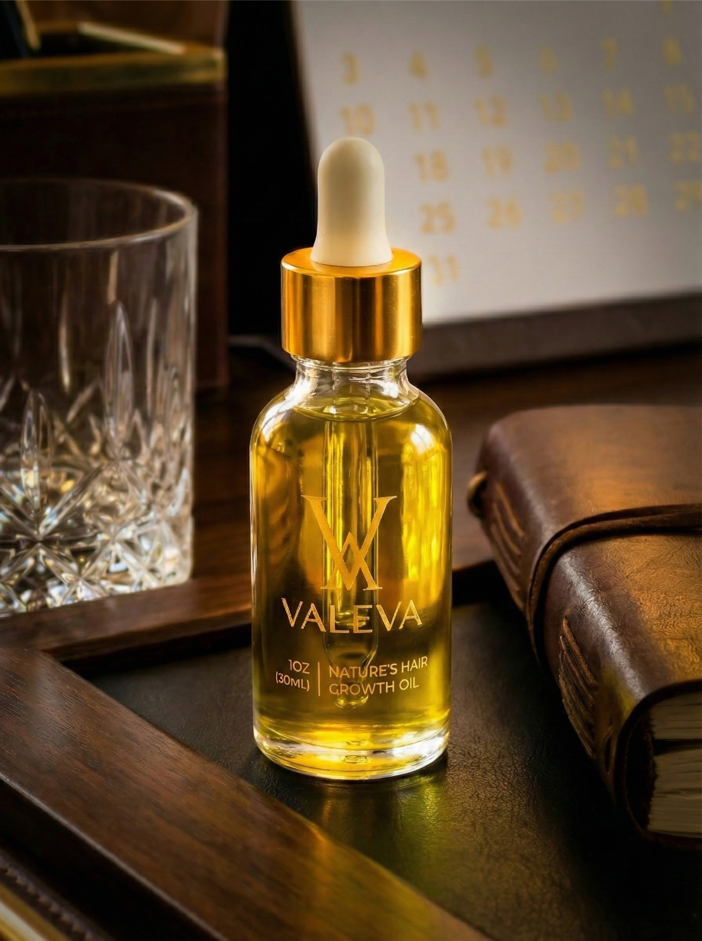 Bottle of Valeva hair growth oil with a dropper on a wooden tray.