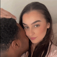 A couple sharing an affectionate moment, with one person resting against the other's shoulder.