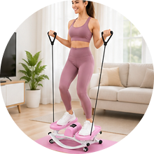 A woman in pink workout gear uses a mini stepper with resistance bands in a living room.