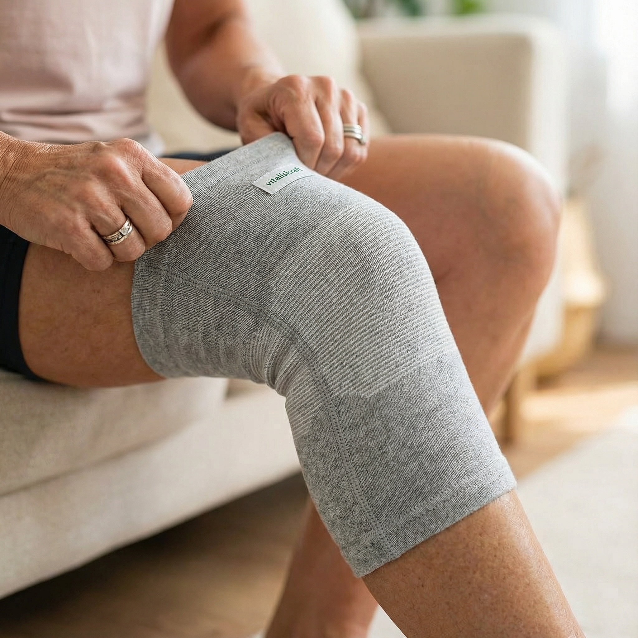 Person wearing a gray knee support sleeve.