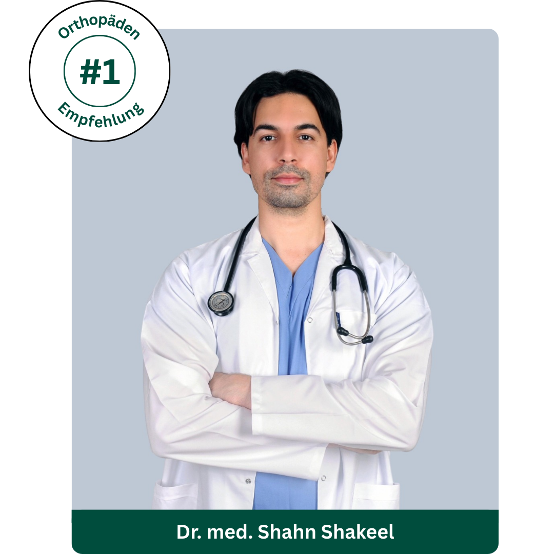 Doctor in white coat with stethoscope, arms crossed, against a gray background.