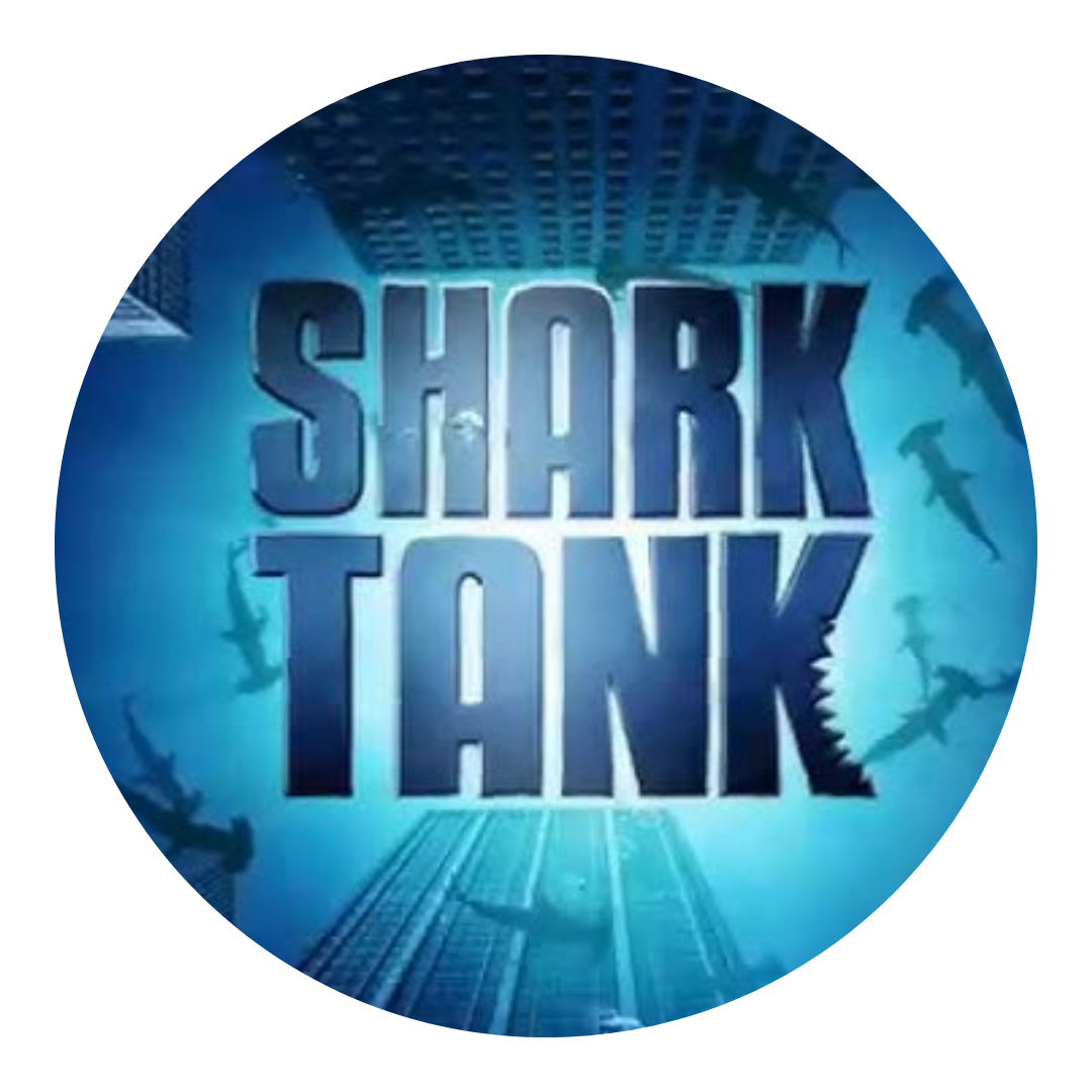 'Shark Tank' text with sharks and buildings in the background.