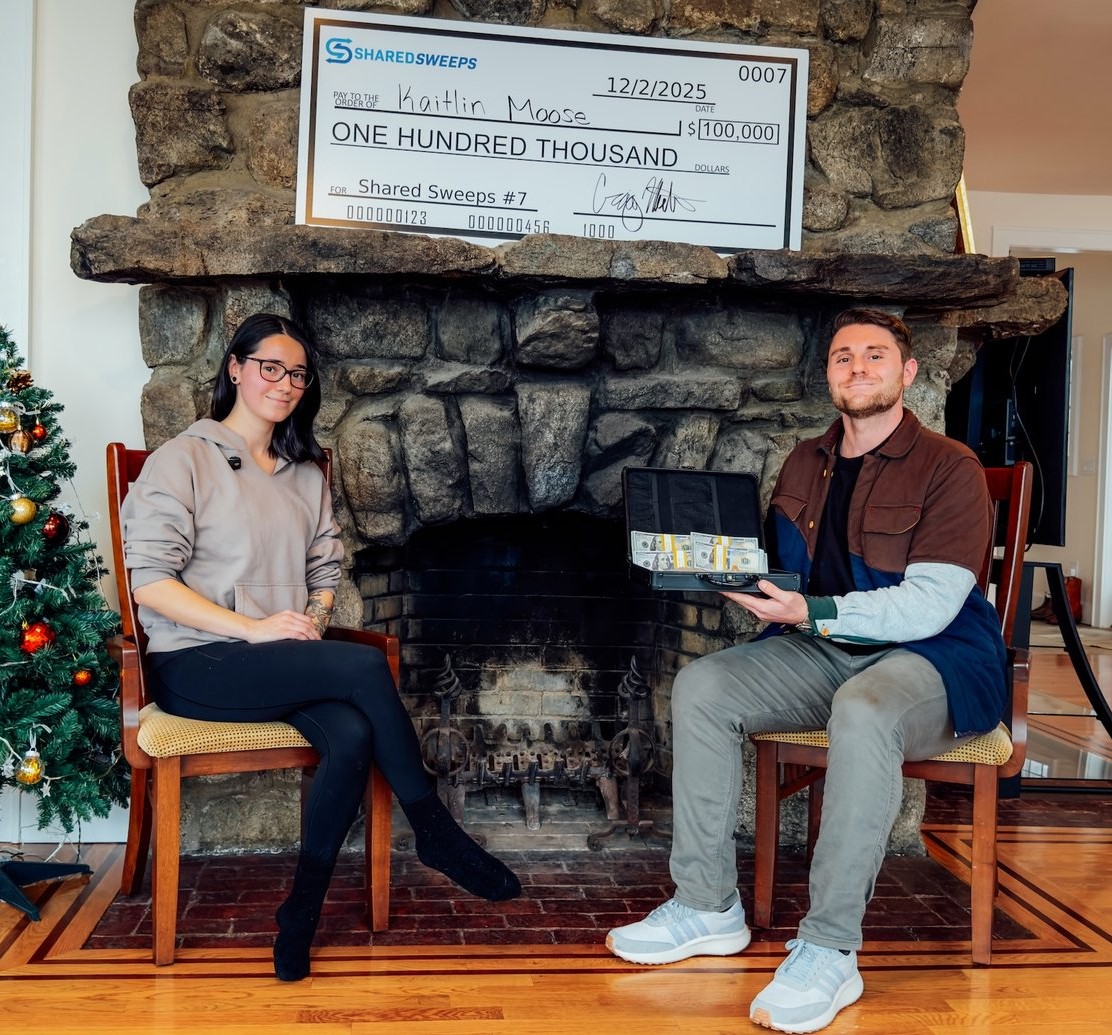 Blue Corvette Stingray on rooftop with 'Win' text and cash graphics.