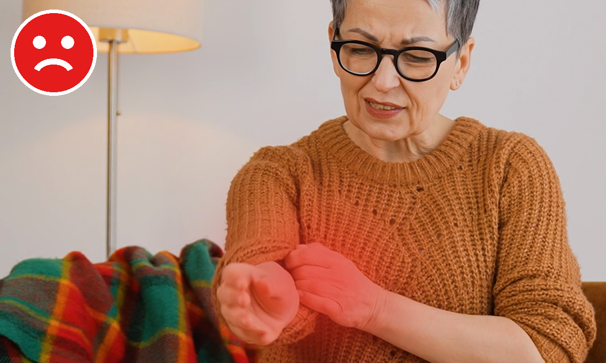 An older woman with a pained expression holds her arm, which is glowing red to indicate pain.