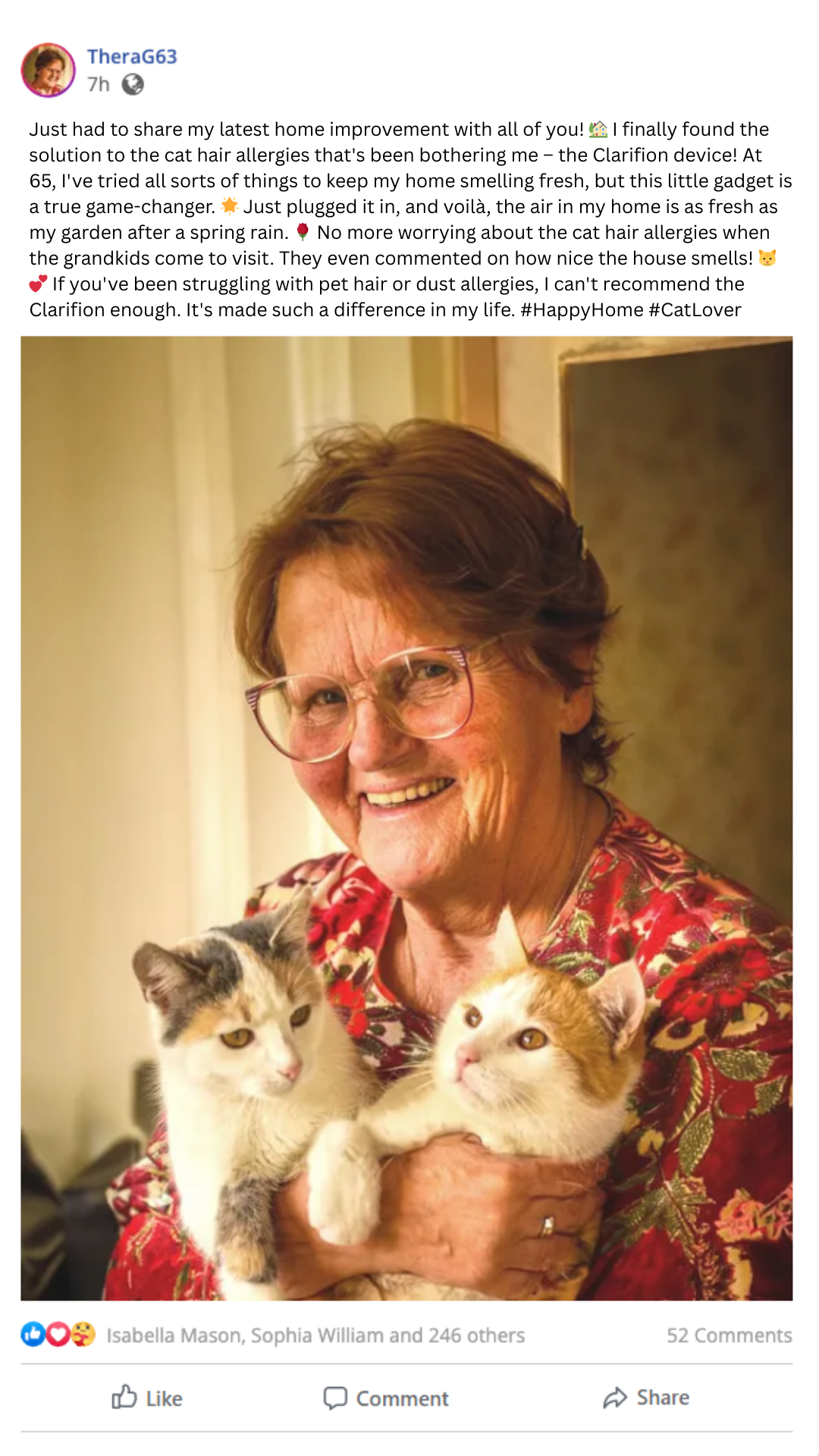 Smiling person holding two cats indoors.