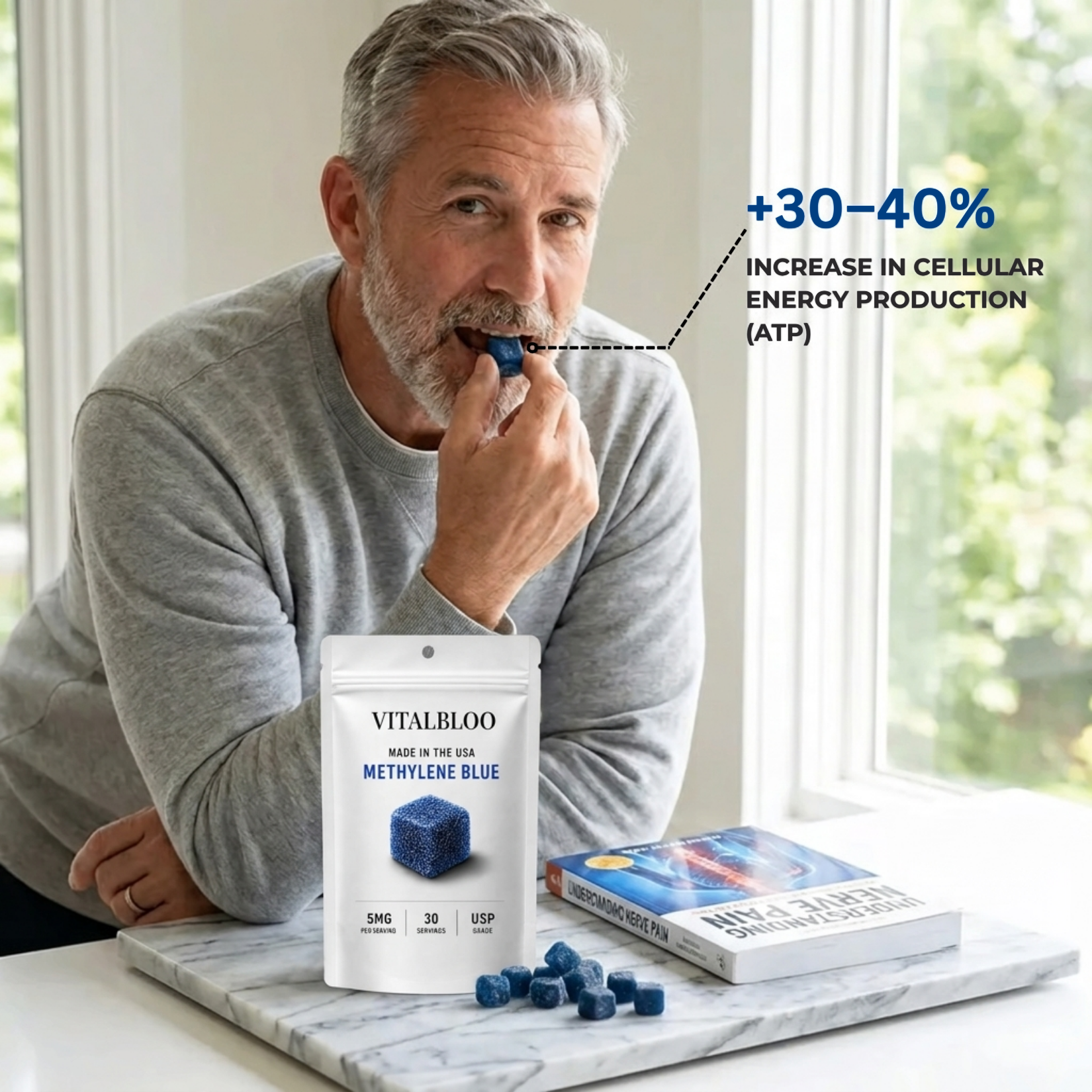A man eats a blue gummy, with a pouch of Vitalbloo Methylene Blue on the counter.