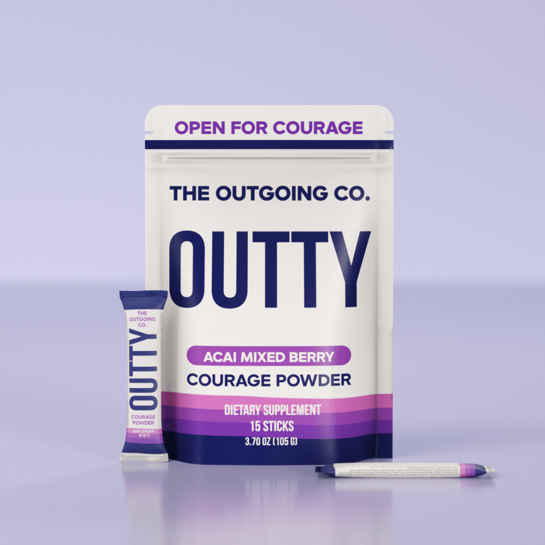 A pouch and stick of The Outgoing Co. Outty Acai Mixed Berry Courage Powder dietary supplement.