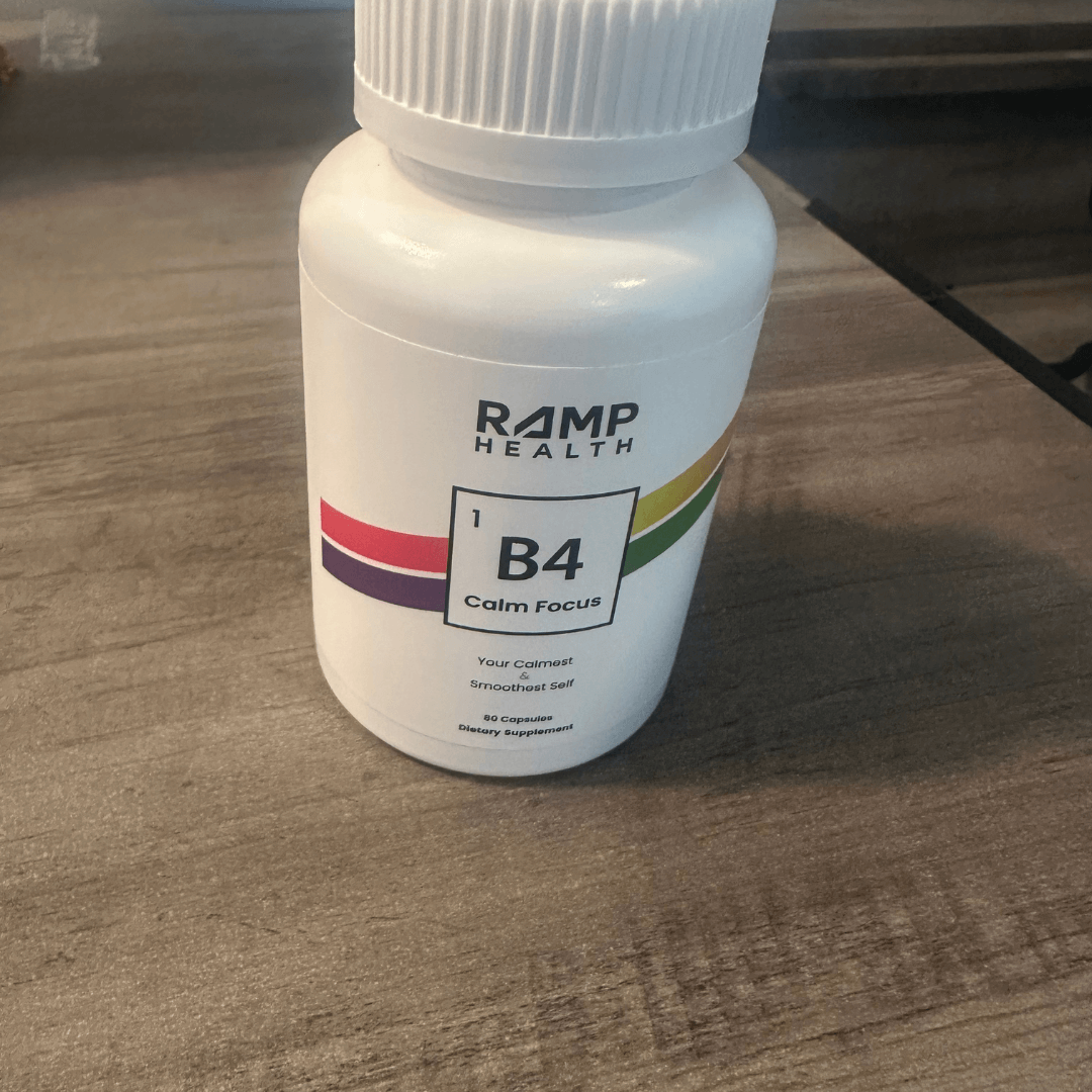 White bottle labeled 'RAMP Health B4 Calm Focus' on a wooden surface.