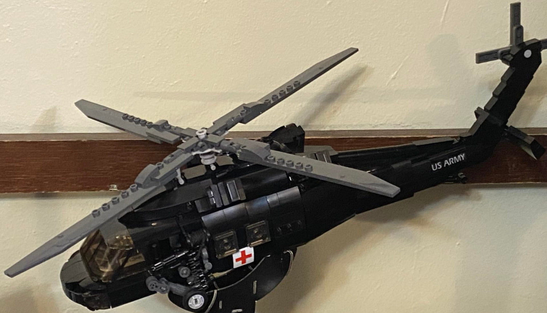 A black toy model of a US Army medical helicopter made from building blocks.