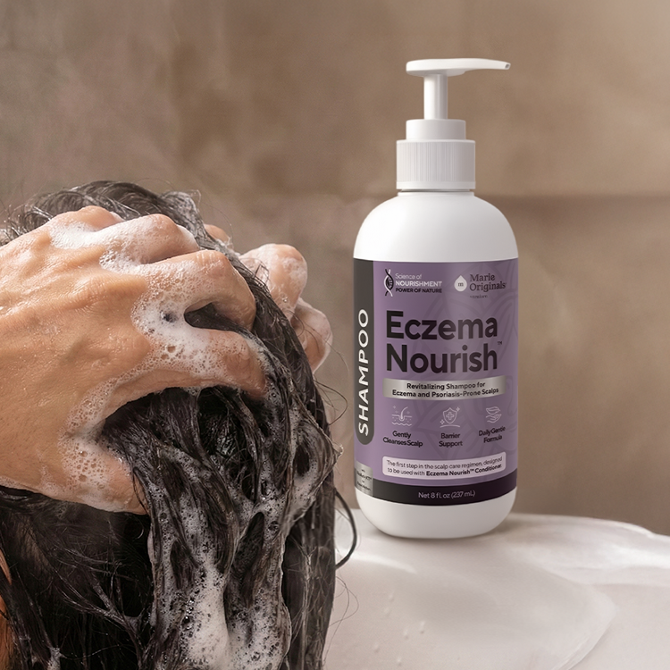 A person lathers their dark hair next to a bottle of Marie Originals Eczema Nourish shampoo.