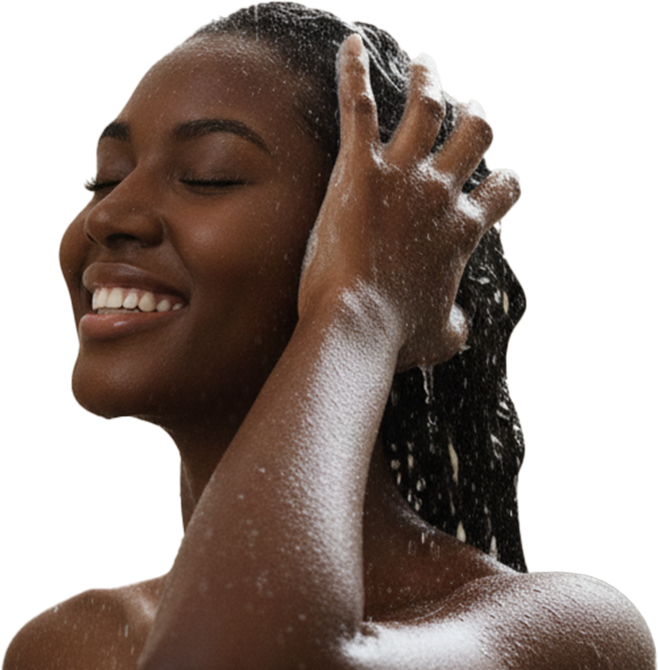 A smiling Black woman with her eyes closed, lathering shampoo into her wet hair.