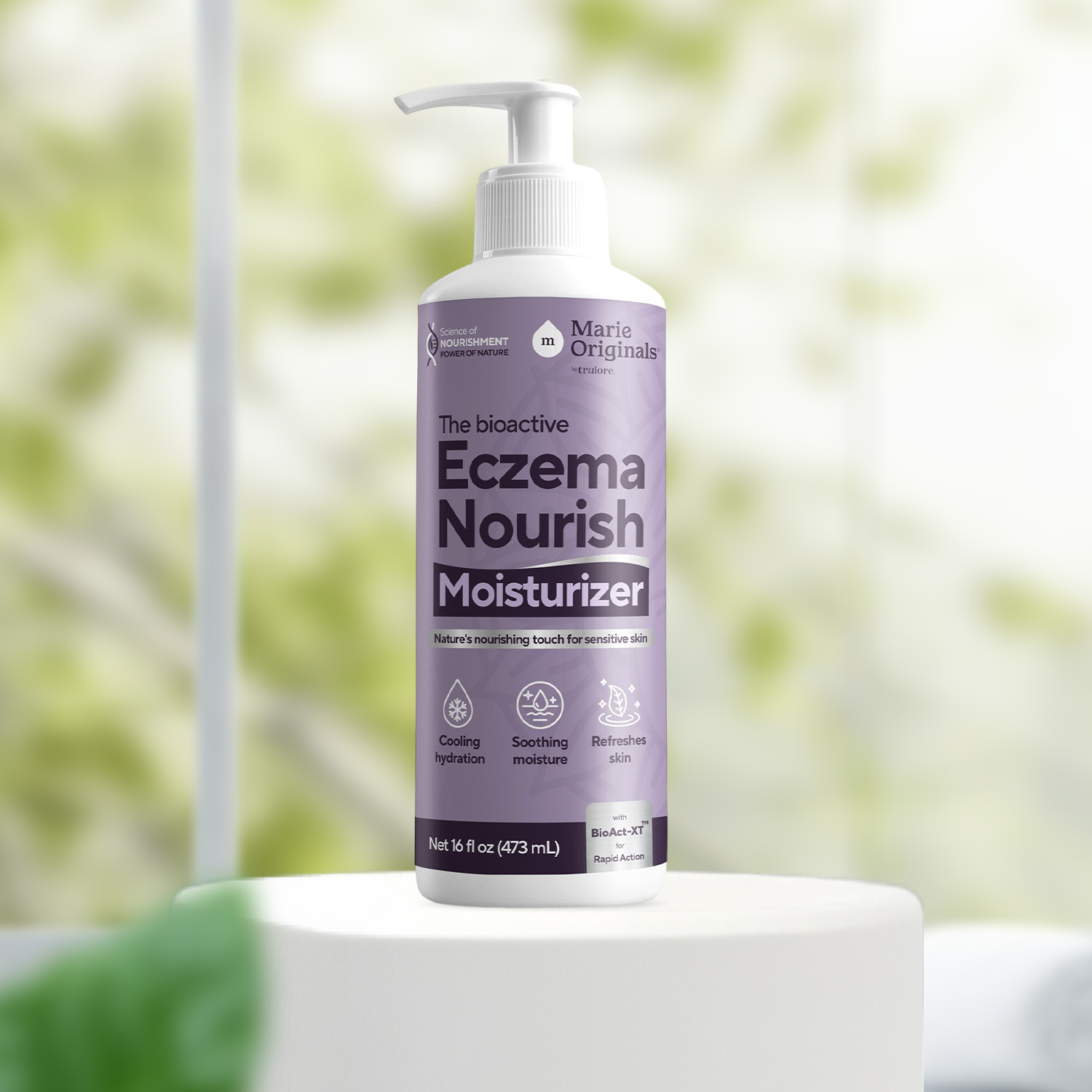 A pump bottle of Marie Originals Eczema Nourish Moisturizer sits on a white pedestal before a window.