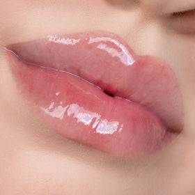 Close-up of glossy, pink lips.