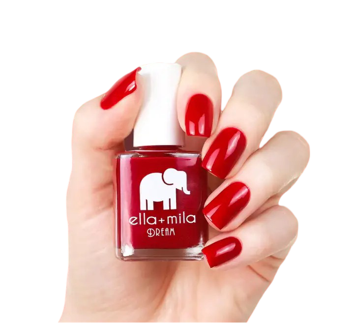 Hand holding a red nail polish bottle with red painted nails.