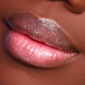 Close-up of lips with glossy pink and silver lipstick.