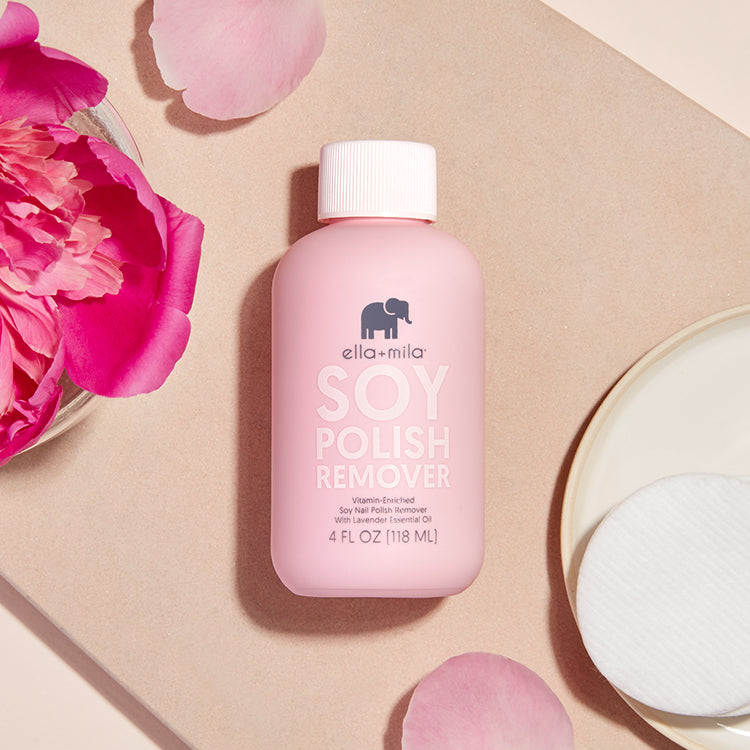 Pink bottle of soy polish remover with pink flowers and cotton pads.