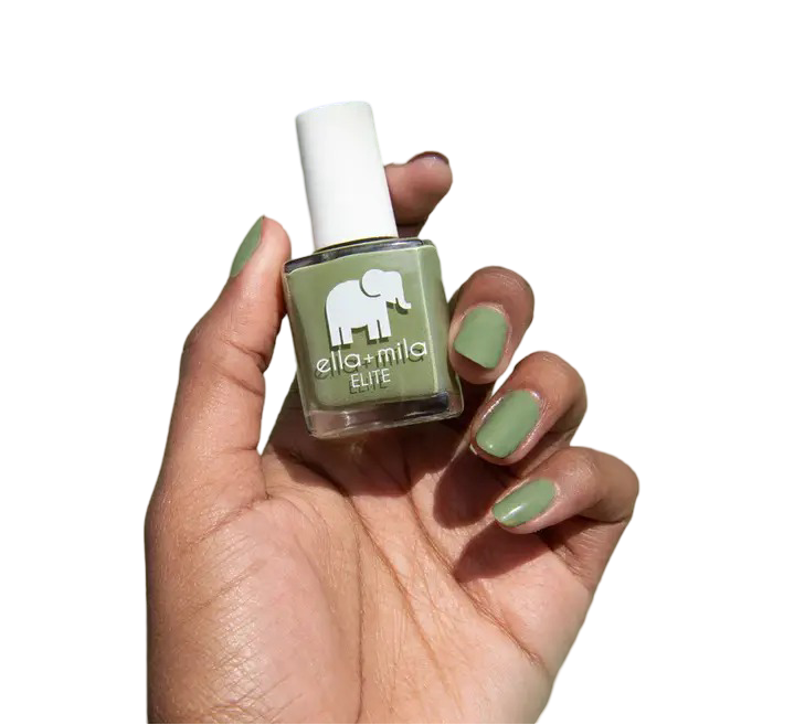 Hand holding a bottle of green nail polish with matching painted nails.