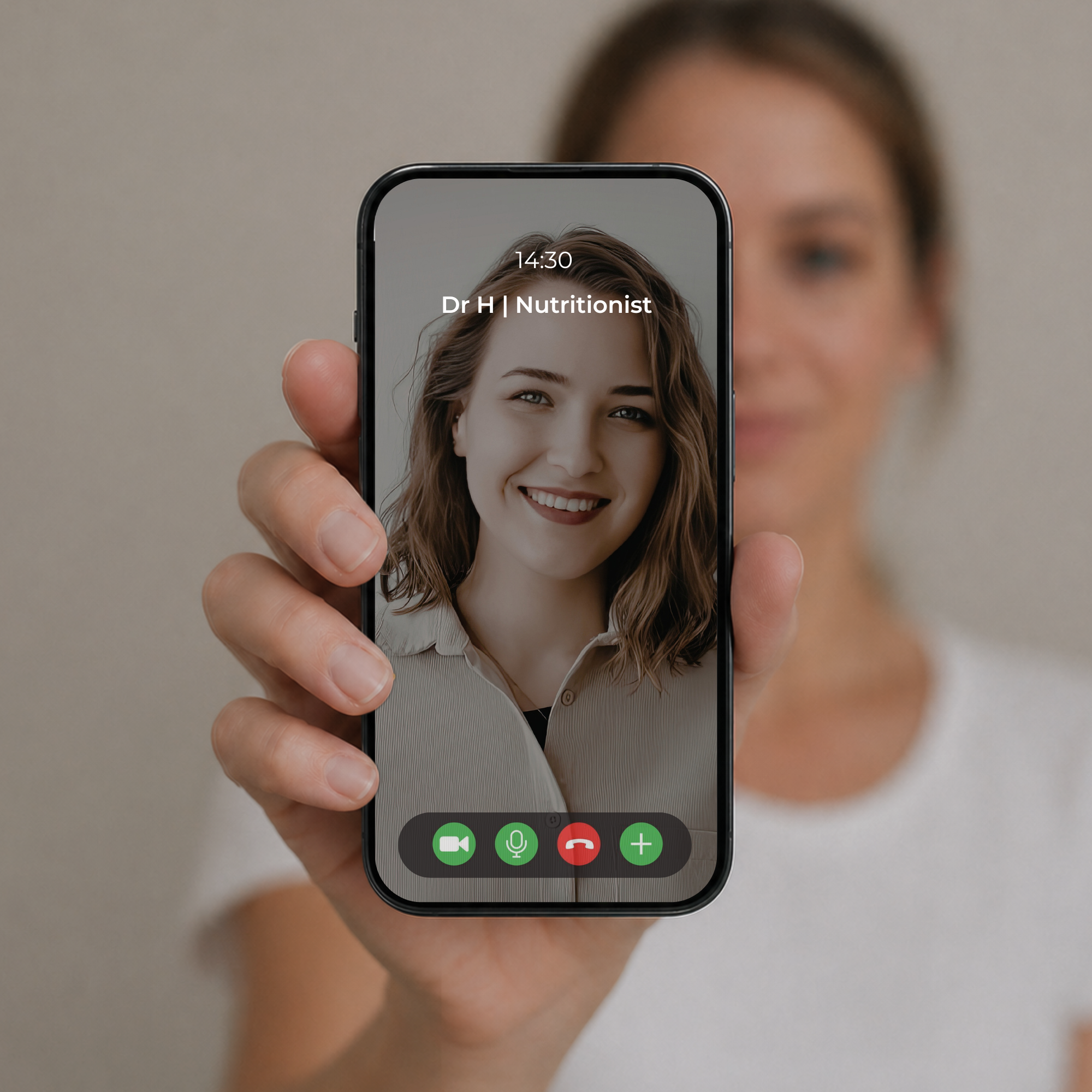 A hand holds a smartphone showing a video call with a smiling nutritionist on the screen.