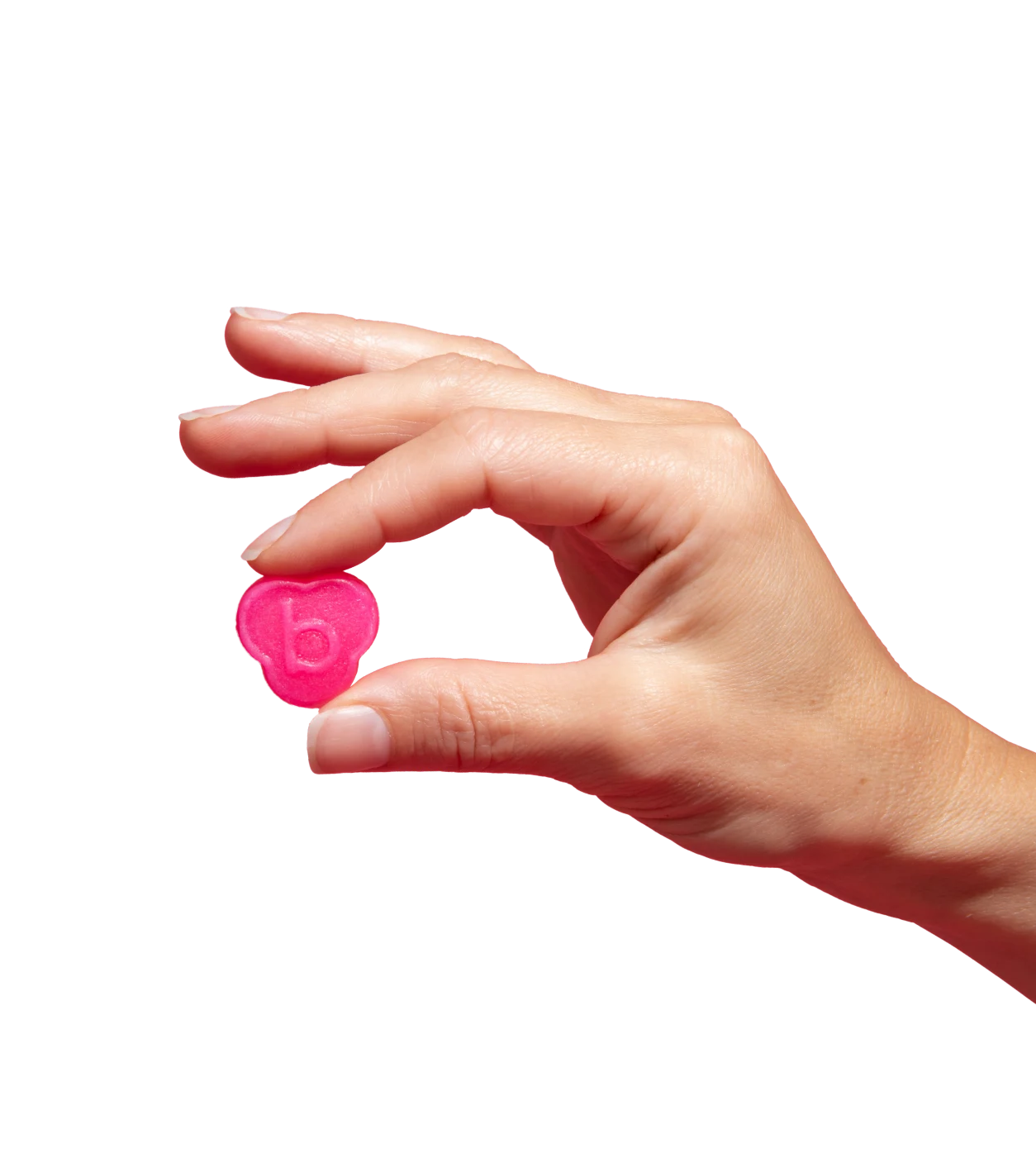 Hand holding a small pink object with a letter 'b' embossed.