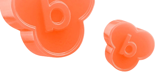 Two orange, flower-shaped objects with the letter 'b' embossed.