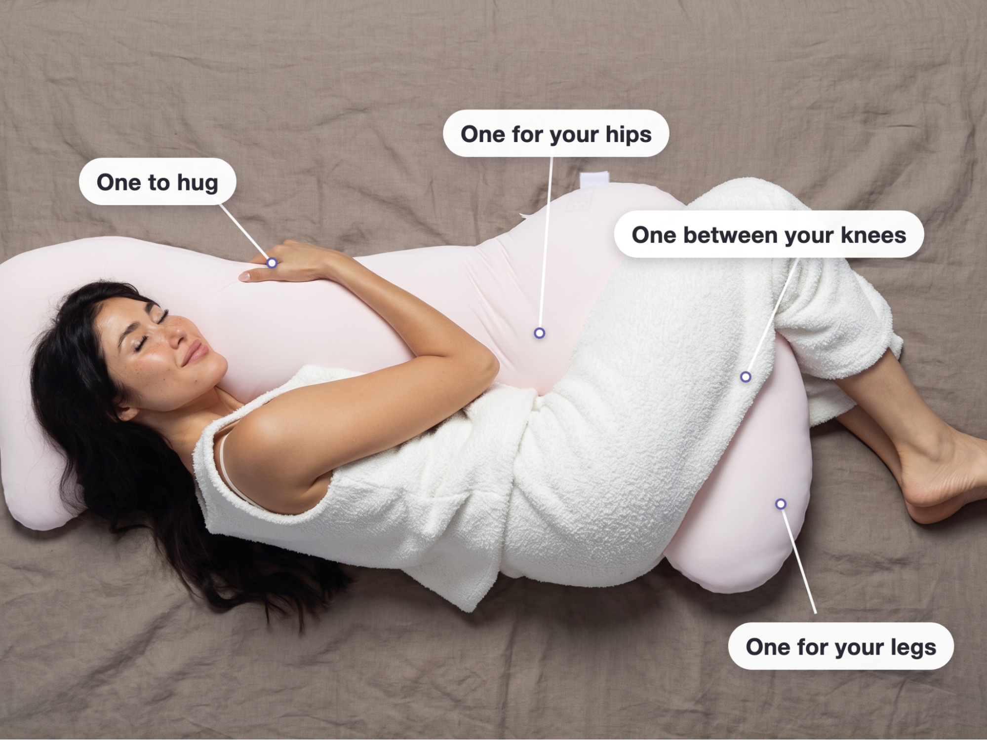 A woman sleeps on her side, hugging a large pink body pillow, with text indicating its features.