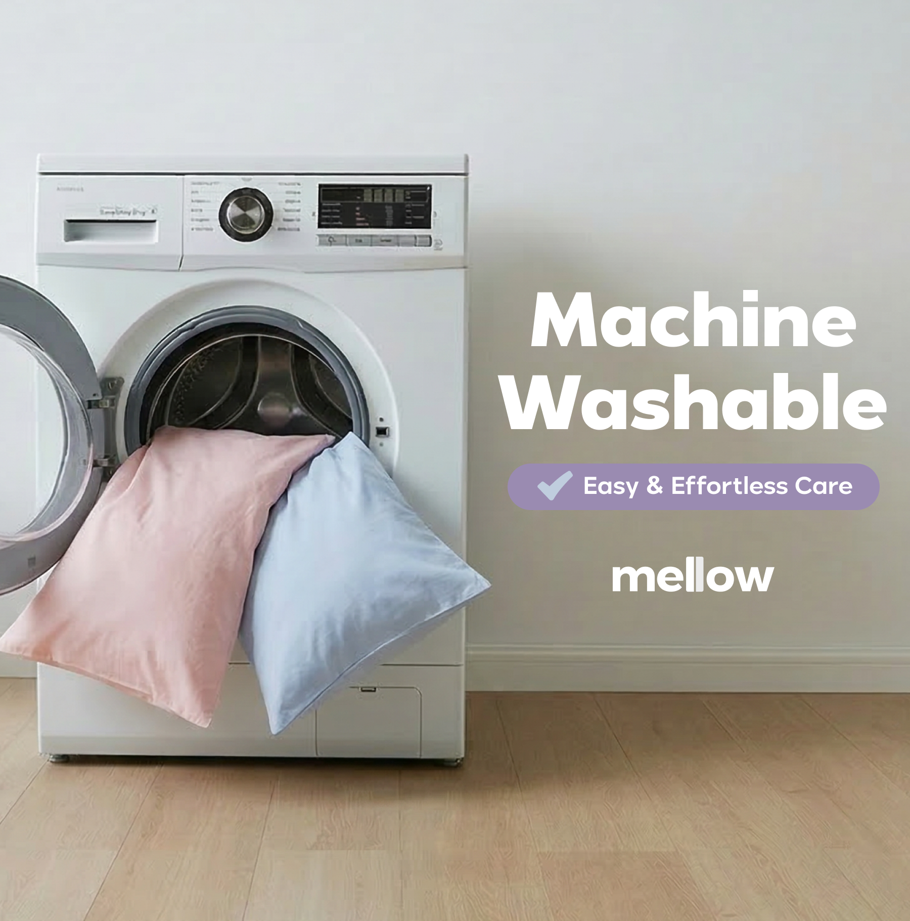 A pink and a blue pillow being loaded into a front-loading washing machine.