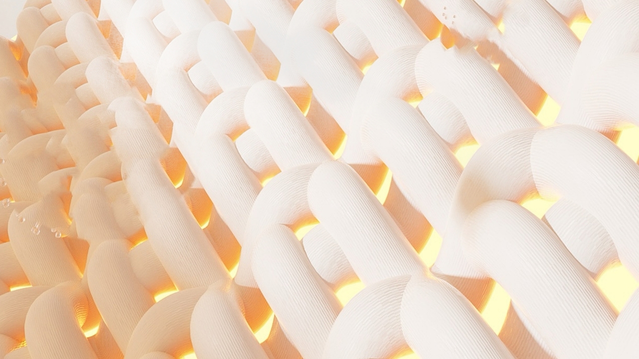 A close-up of white, interlocking, textured fibers with a warm yellow light glowing from behind them.