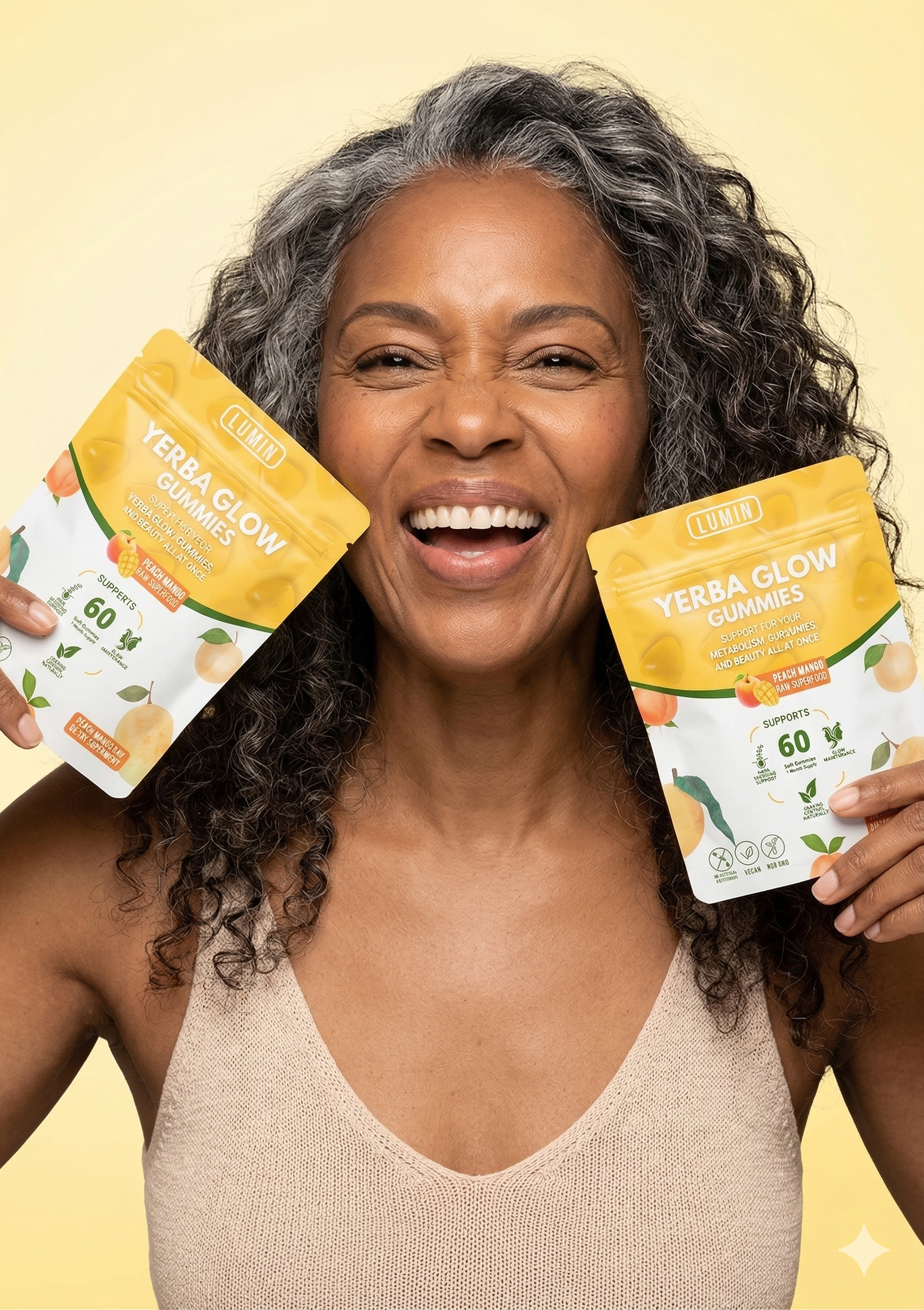 A smiling woman with gray curly hair holds up two yellow pouches of Yerba Glow Gummies.