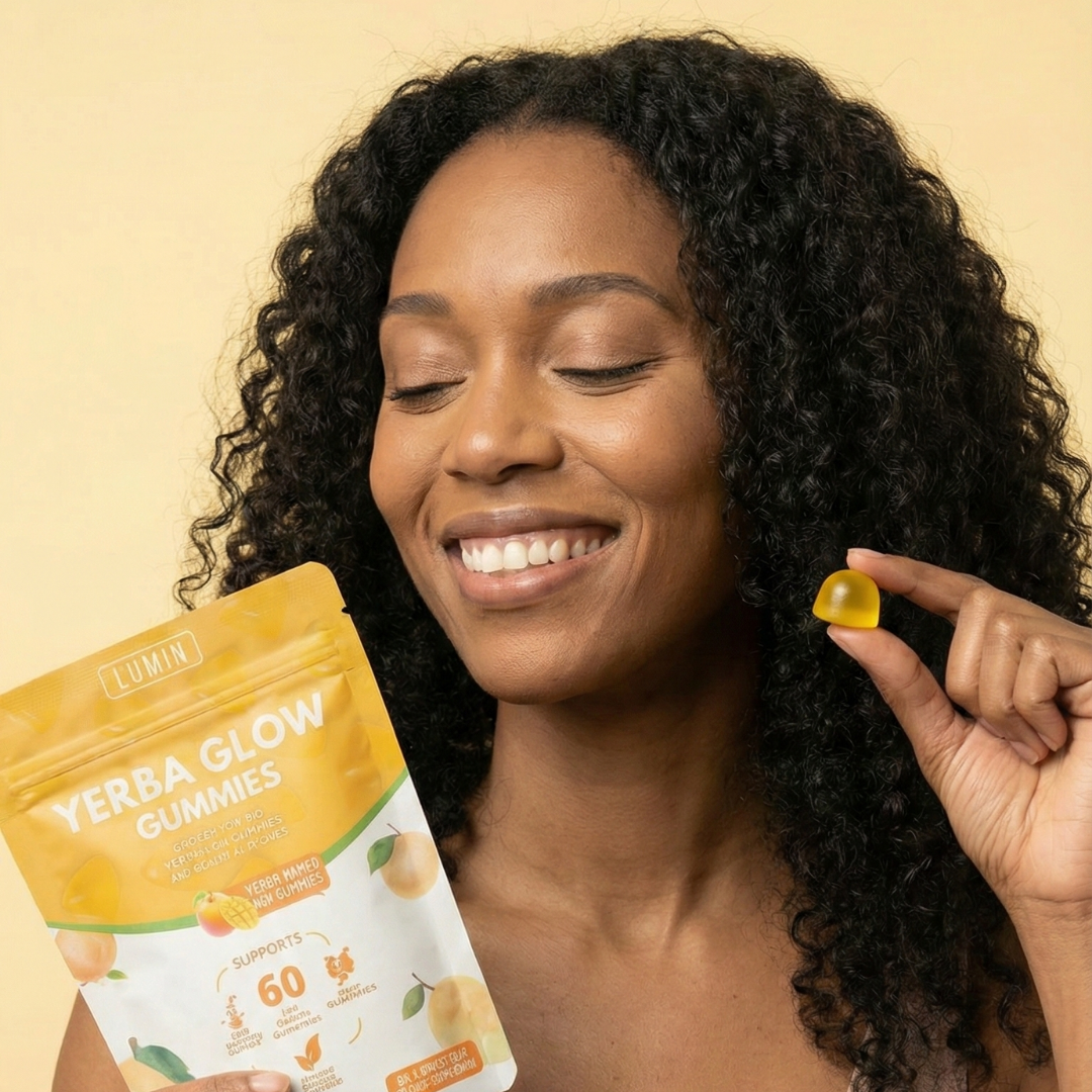 A smiling woman holds a pouch of Yerba Glow Gummies and a single yellow gummy.