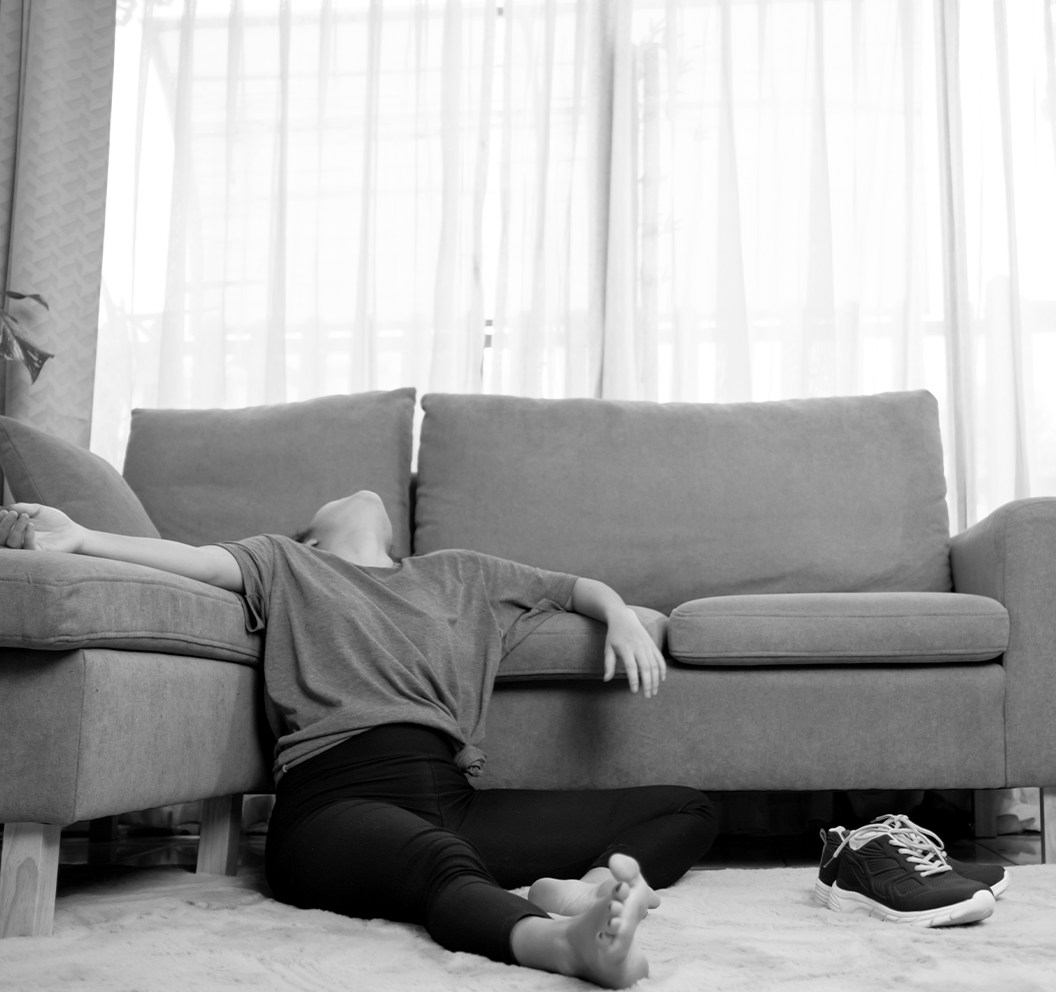 Close-up of a person's forehead and hand touching hairline.