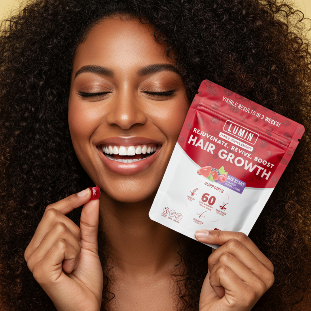 Smiling person holding hair growth supplement package and gummy.