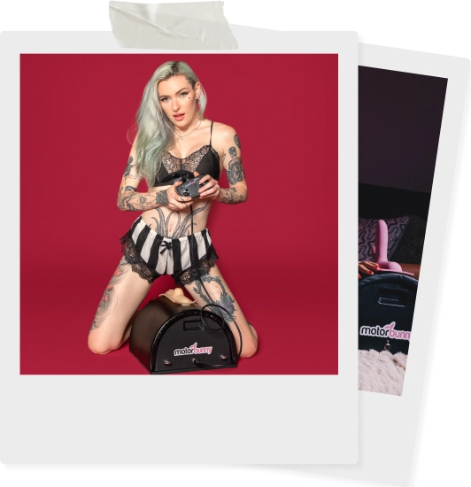 A tattooed woman in lingerie kneels on sex machine motorbunny
holding a control device