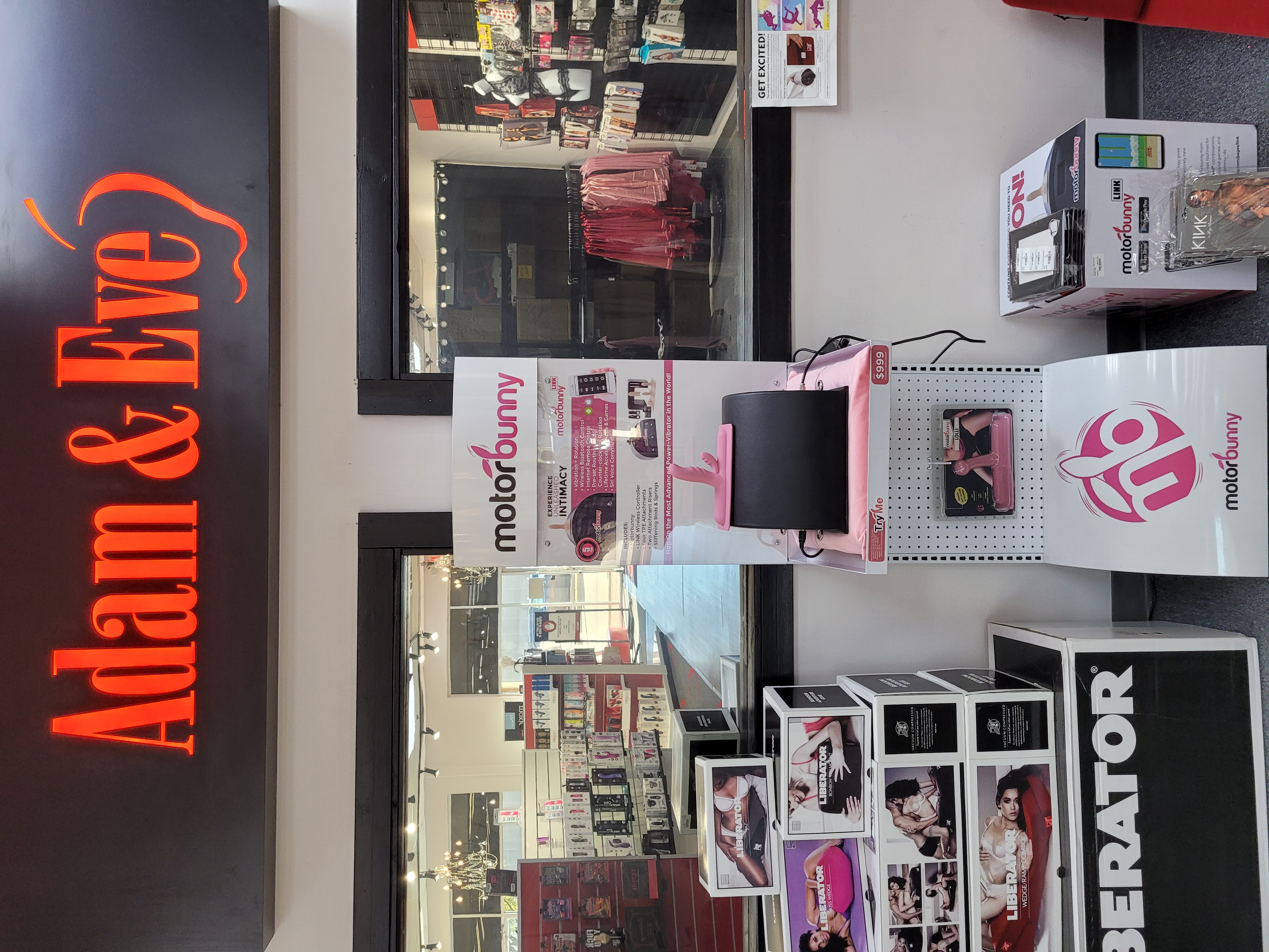 Store display with 'Adam & Eve' sign and Motorbunny product showcase.