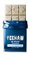 A partially unwrapped Yeehaw candy bar with a shiny blue wrapper, showing the segmented white bar inside.