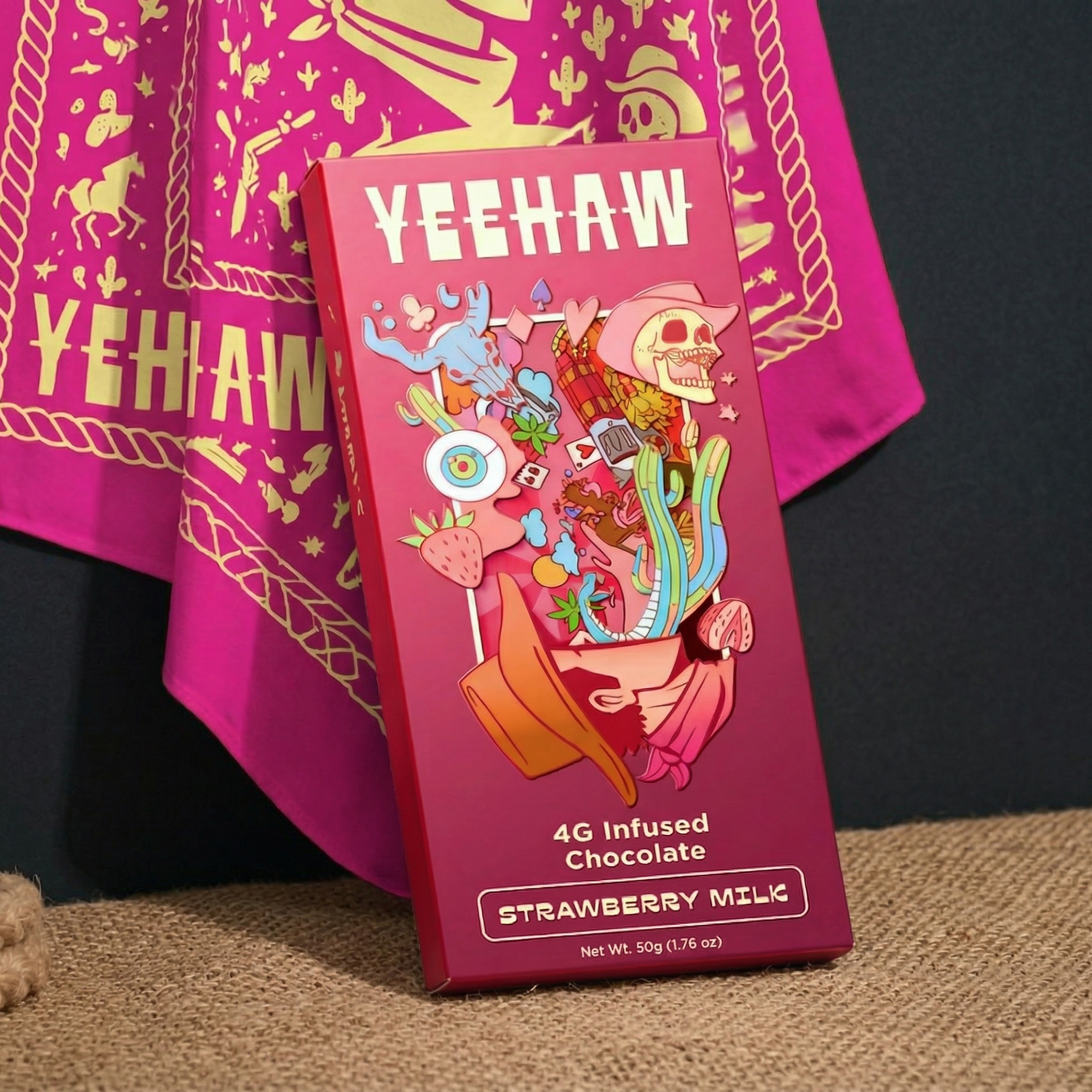 Three colorful boxes of 'YEEHAW' infused chocolate with psychedelic cowboy art inside a black hat.