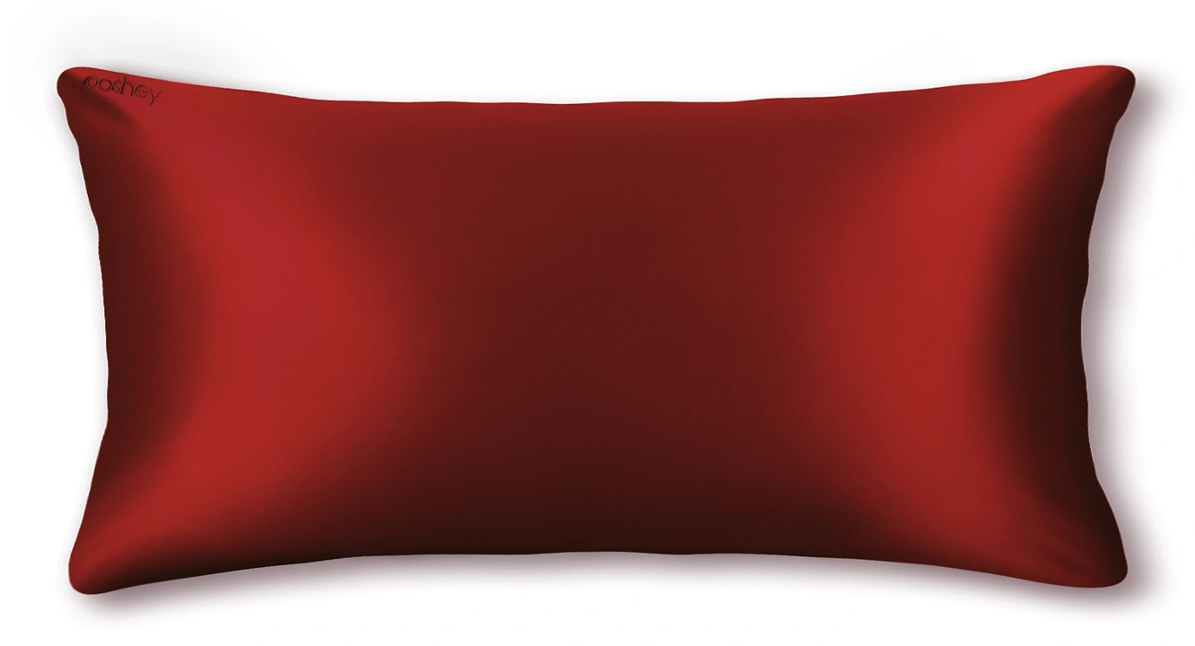A red rectangular pillow with a smooth texture.