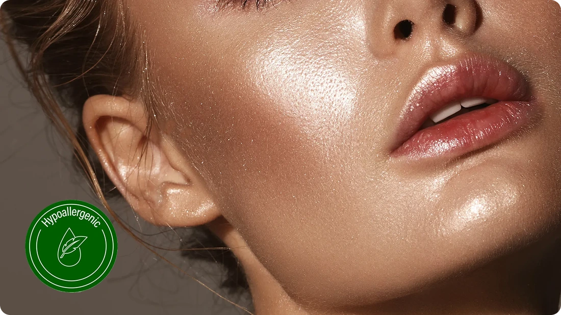 Close-up of a woman's glossy skin and lips with a hypoallergenic label.