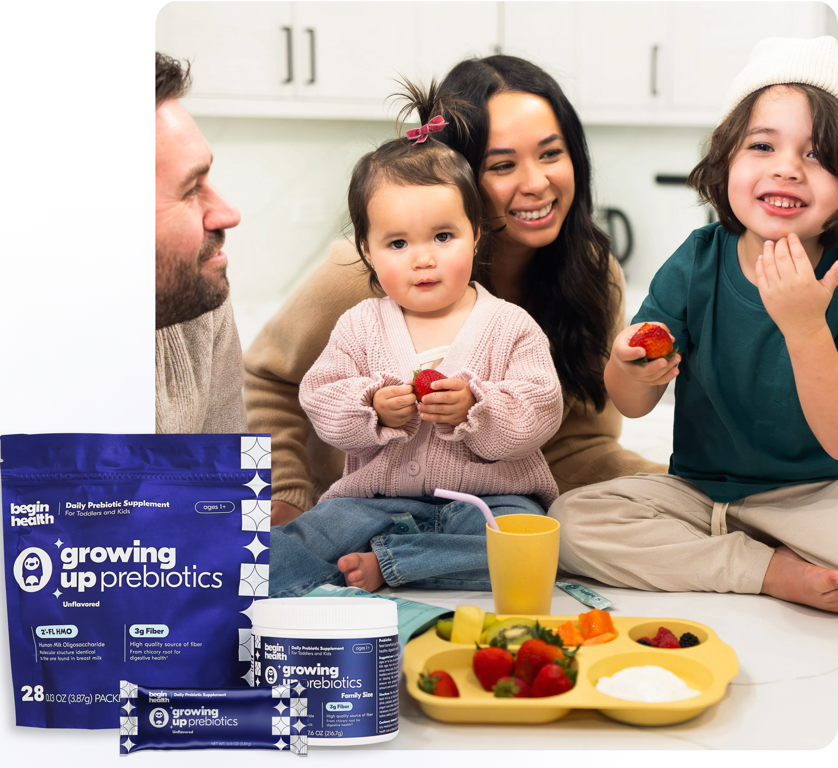 Family with children eating strawberries, prebiotic supplements and fruit tray on table.
