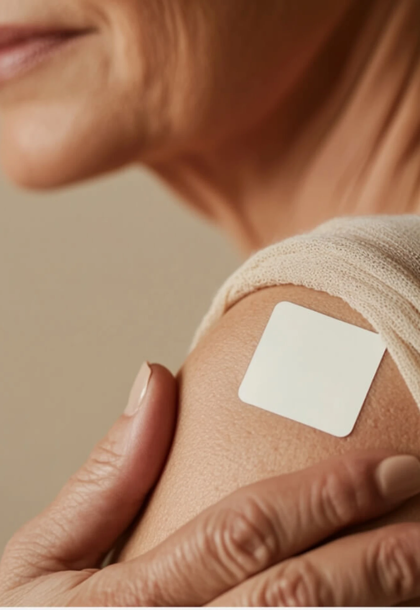 Person with a white adhesive patch on their shoulder.
