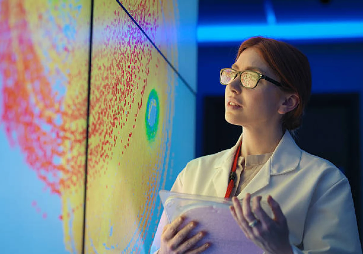 Scientist analyzing weather patterns on a digital display screen.