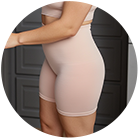 Person wearing beige workout shorts and top in a kitchen setting.